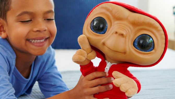 boy playing with E.T. toy